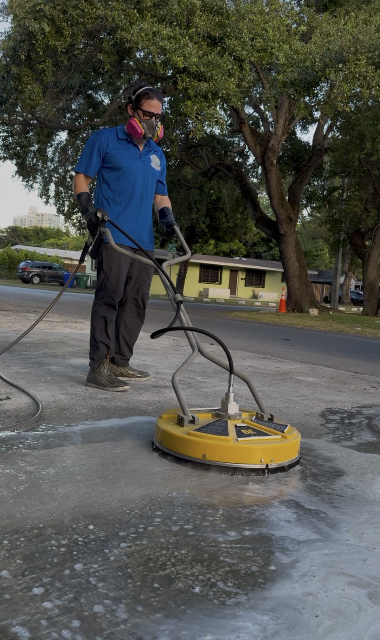 PowerGator pressure washing a driveway with a surface cleaner